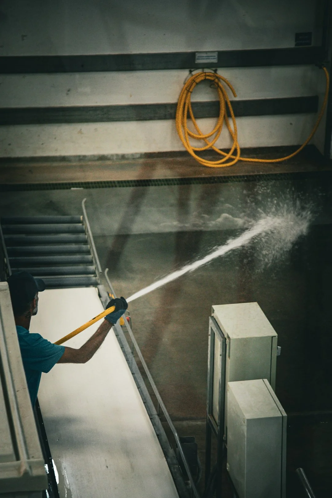 A cleaner is mopping the floor inside a laboratory setting